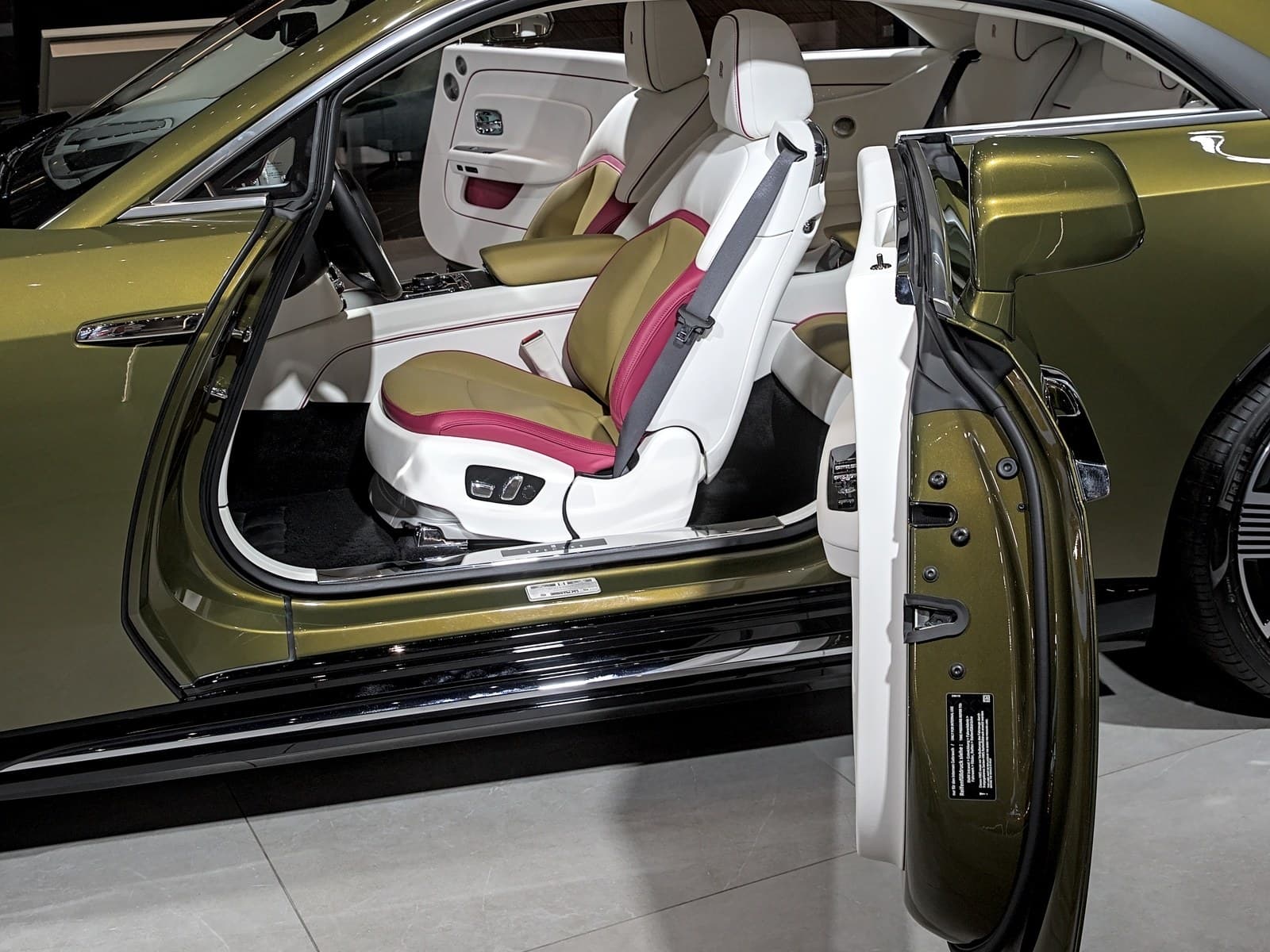 Rolls-Royce Spectre verde, porta controvento aperta sul sedile anteriore